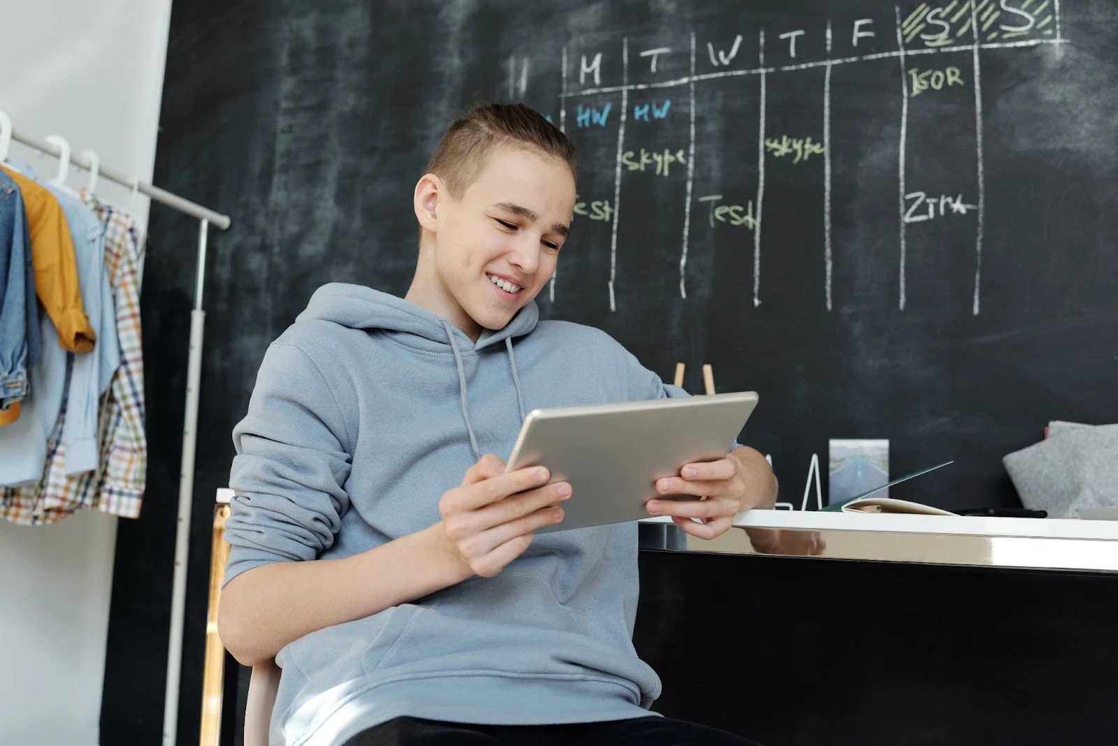 Image depicting a person doing online quizzes on his tablet