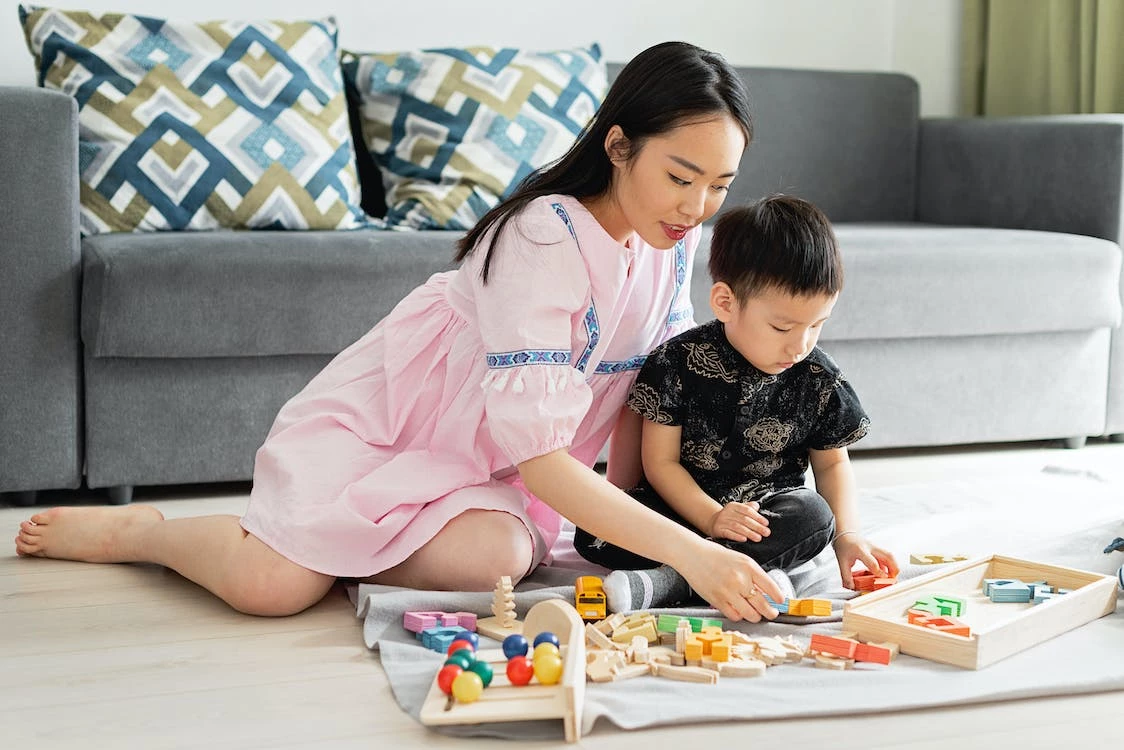 A mom and a child playing with toys