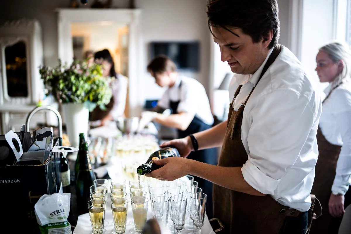 Restaurant staff pouring drinks